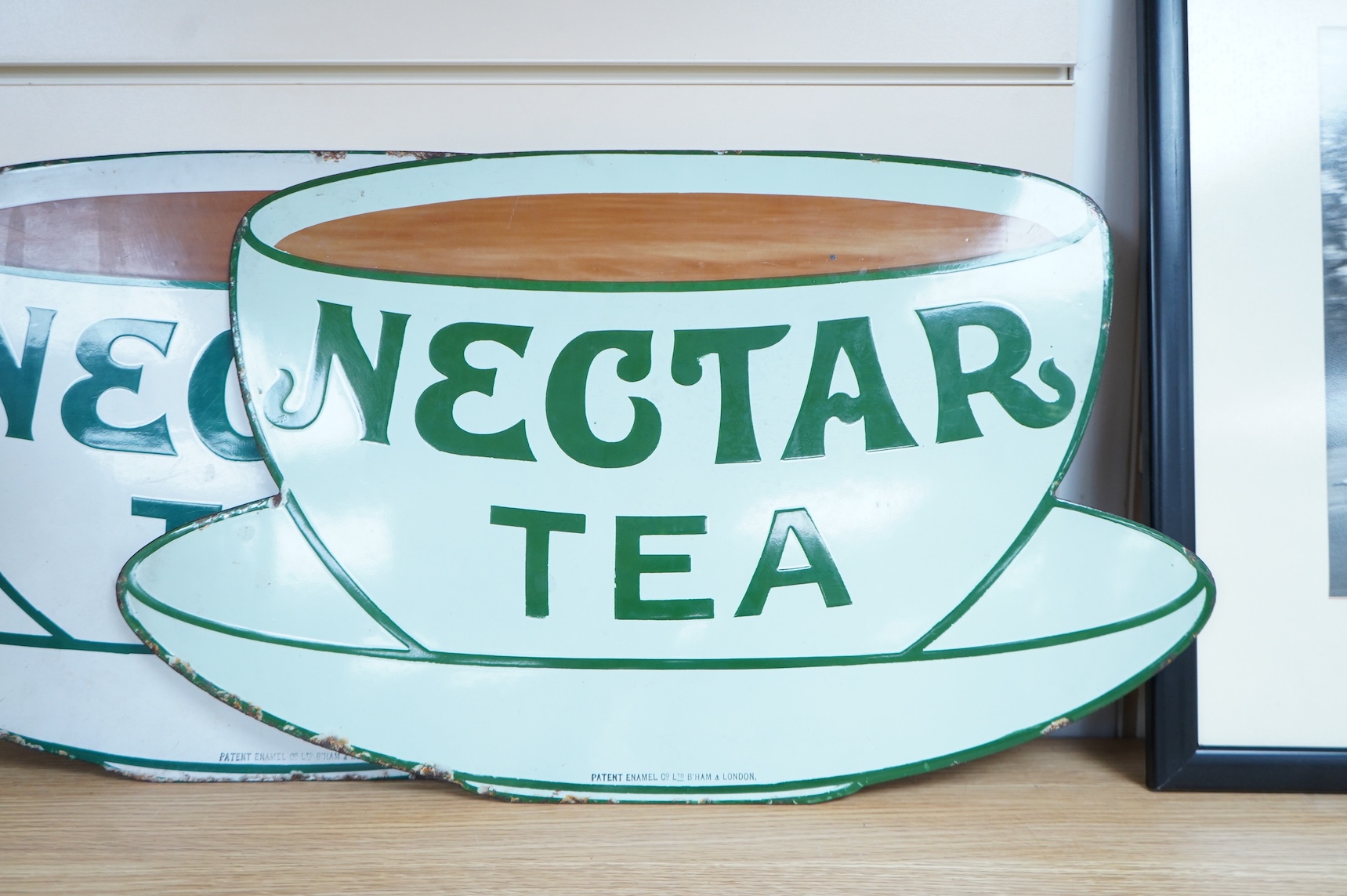 Two Nectar Tea enamel advertising signs, both with original ‘Directions for Hanging’ labels pasted onto the reverse with an allocation for Waterloo Station, one also with a W.H. Smith luggage label for ‘Derby For Repairs
